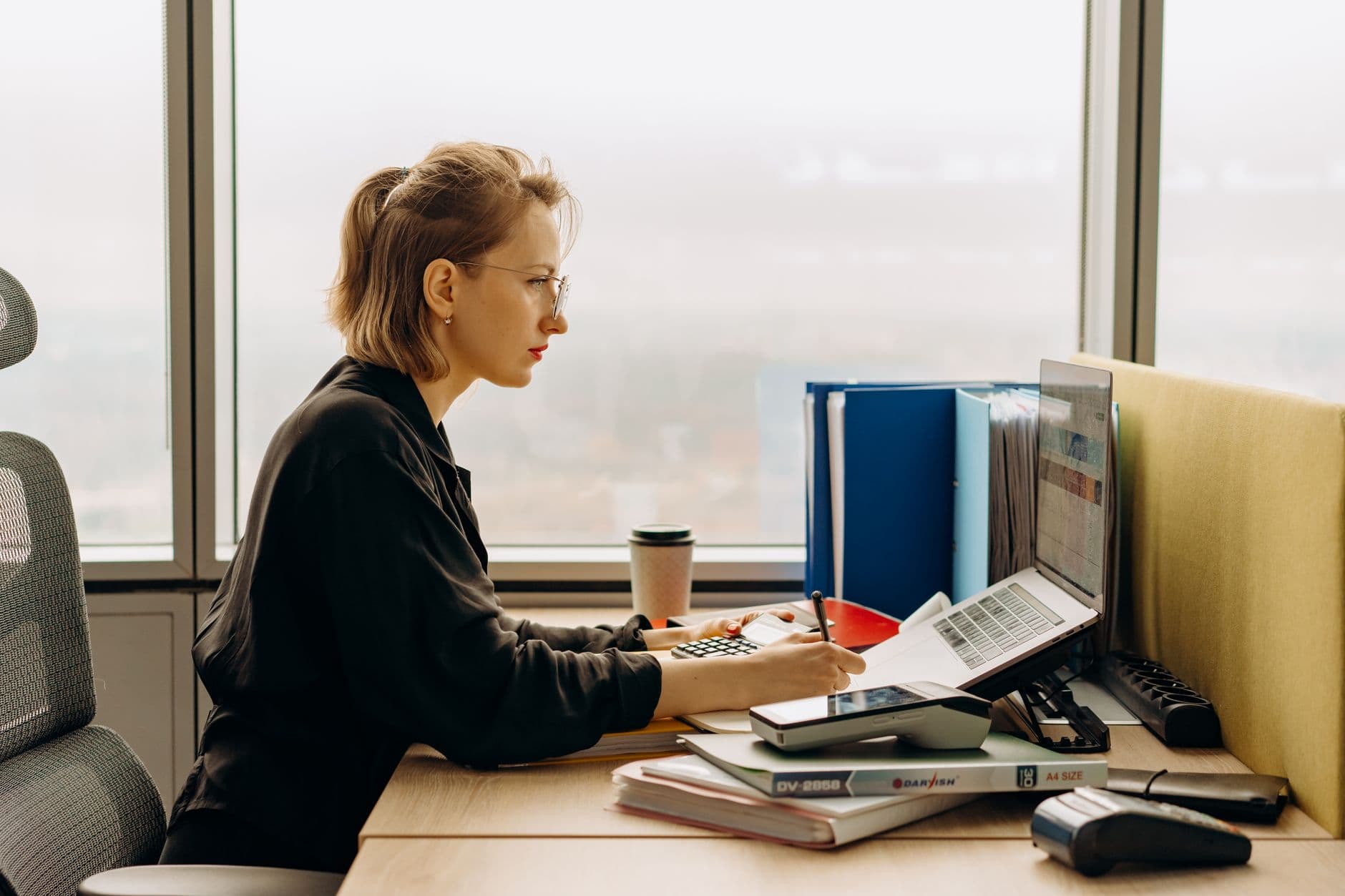 Accountant configuring accounting software on a laptop at a desk