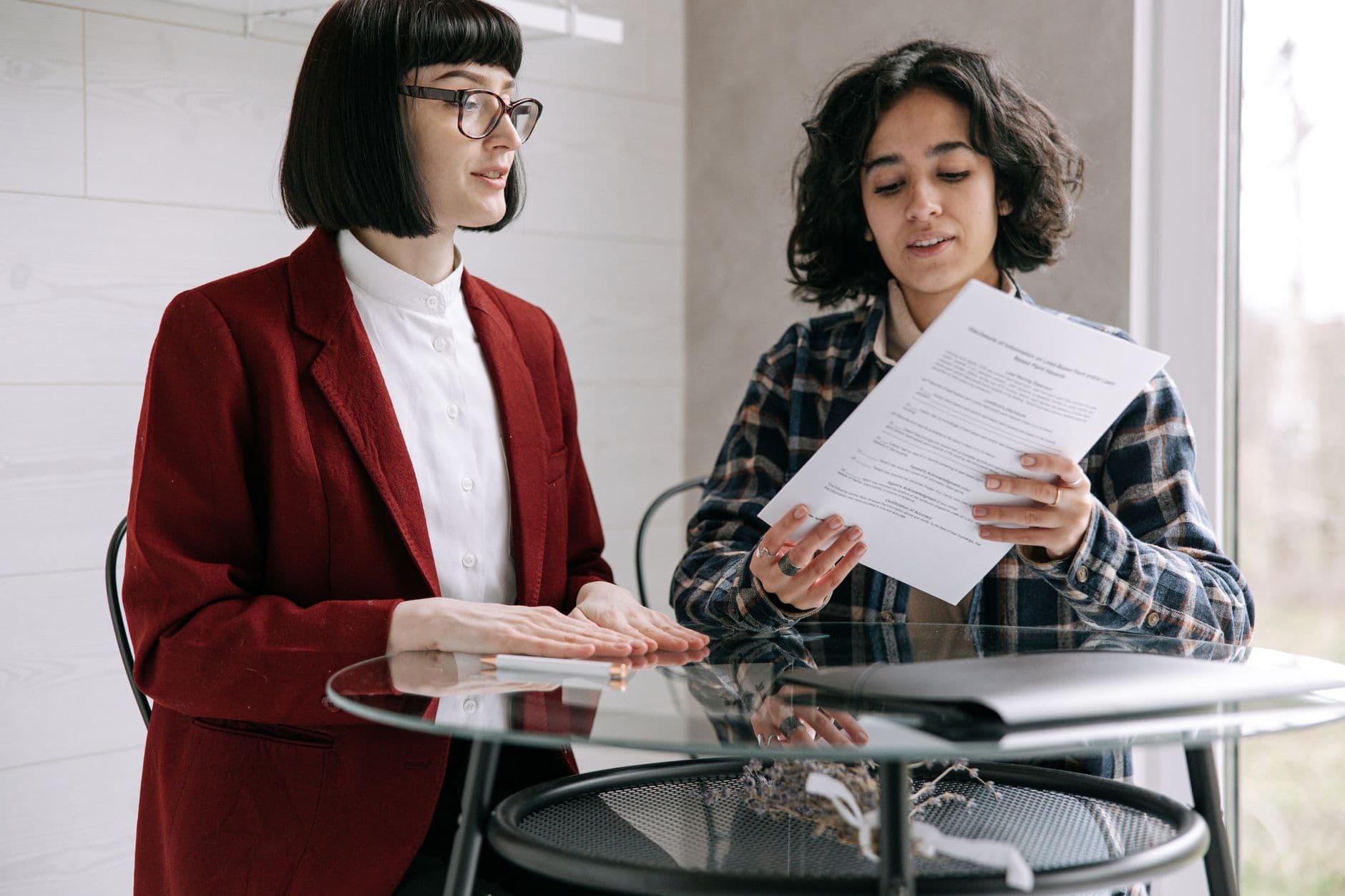 Accountant and farm client reviewing a monthly service checklist together