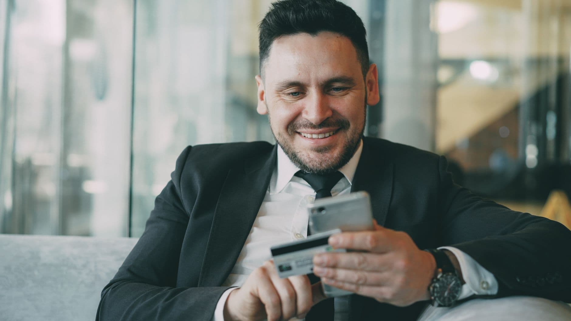 Small business owner reviewing a credit card statement and receipts at a desk