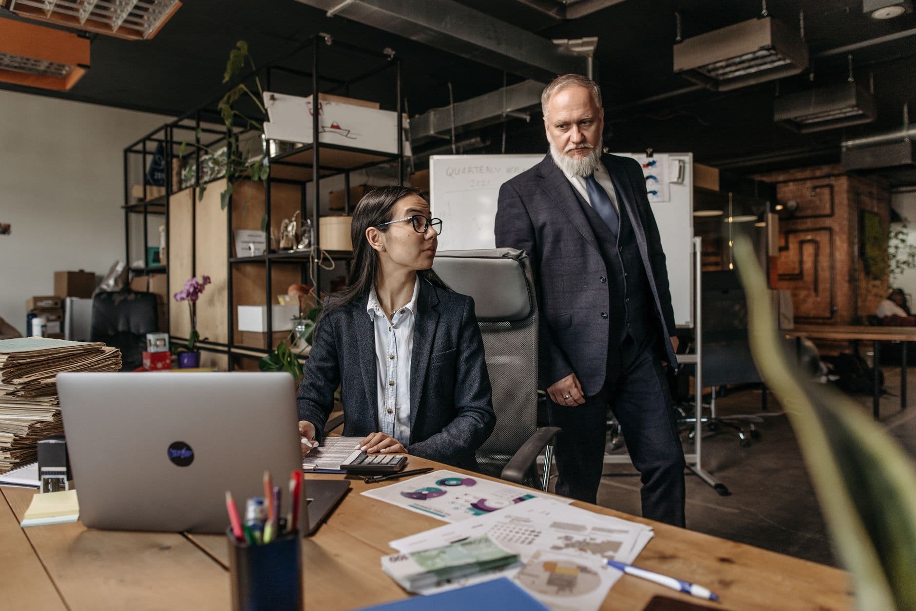 CPA and business owner reviewing entity structure documents at a desk