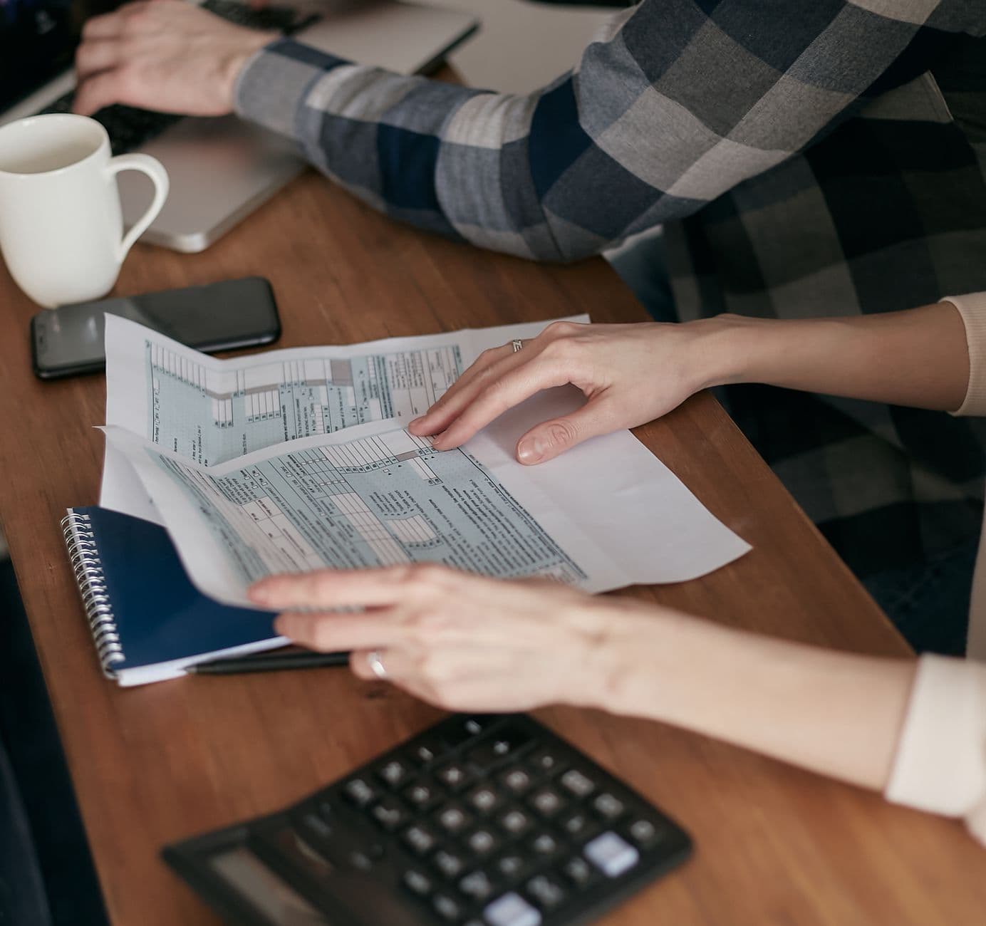 Family reviewing personal tax documents with an accountant at a table
