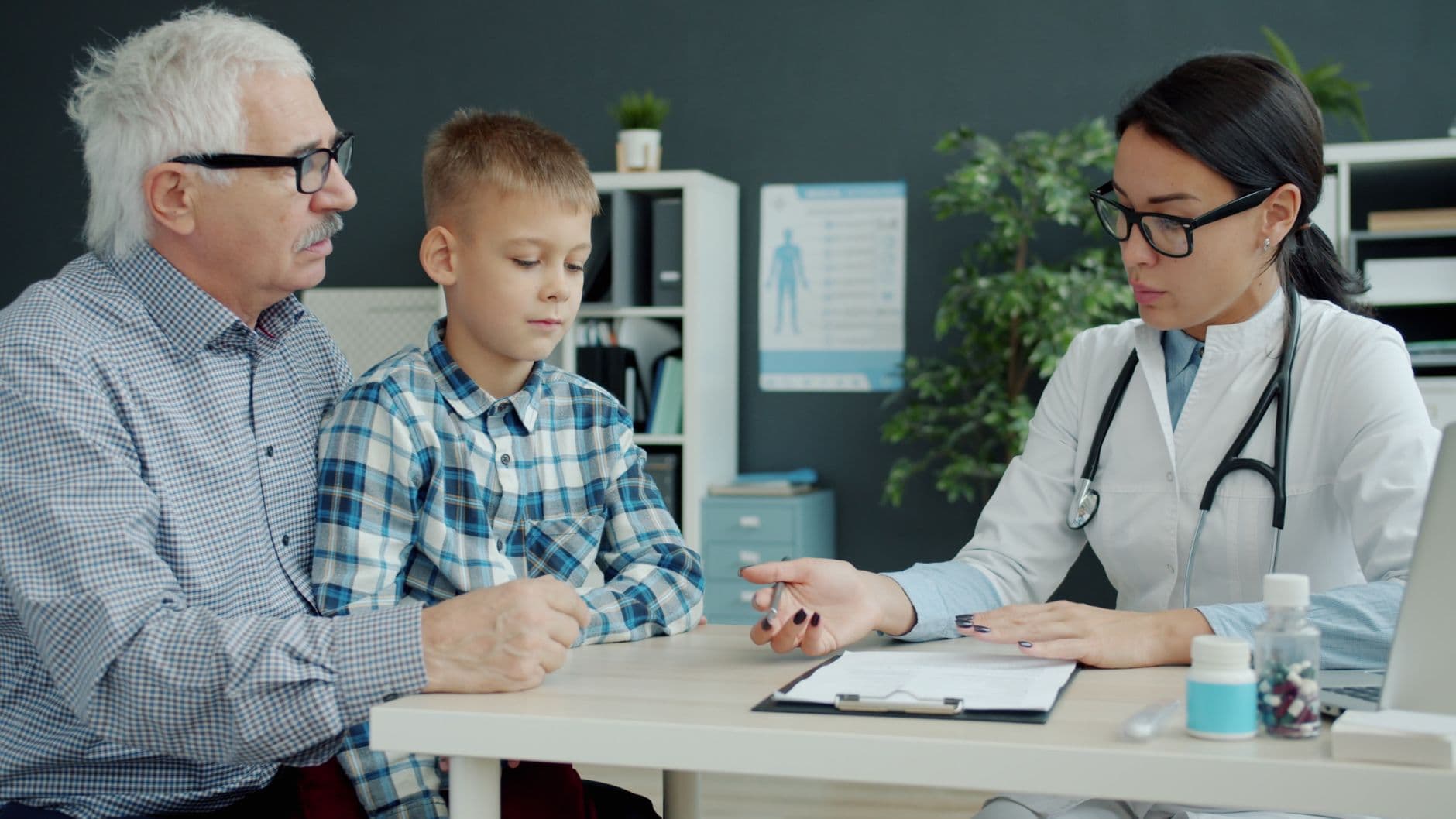 A family reviewing medical bills and tax paperwork together at their kitchen table