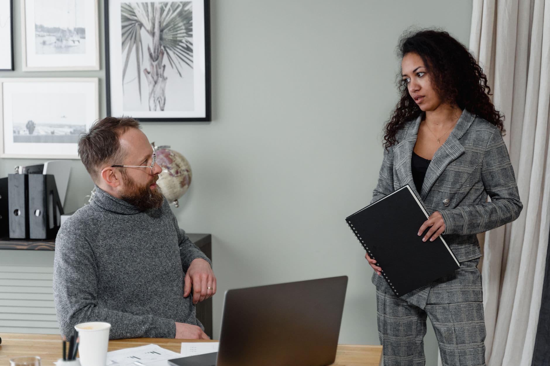 Farmer and accountant reviewing financial reports together in a farm office