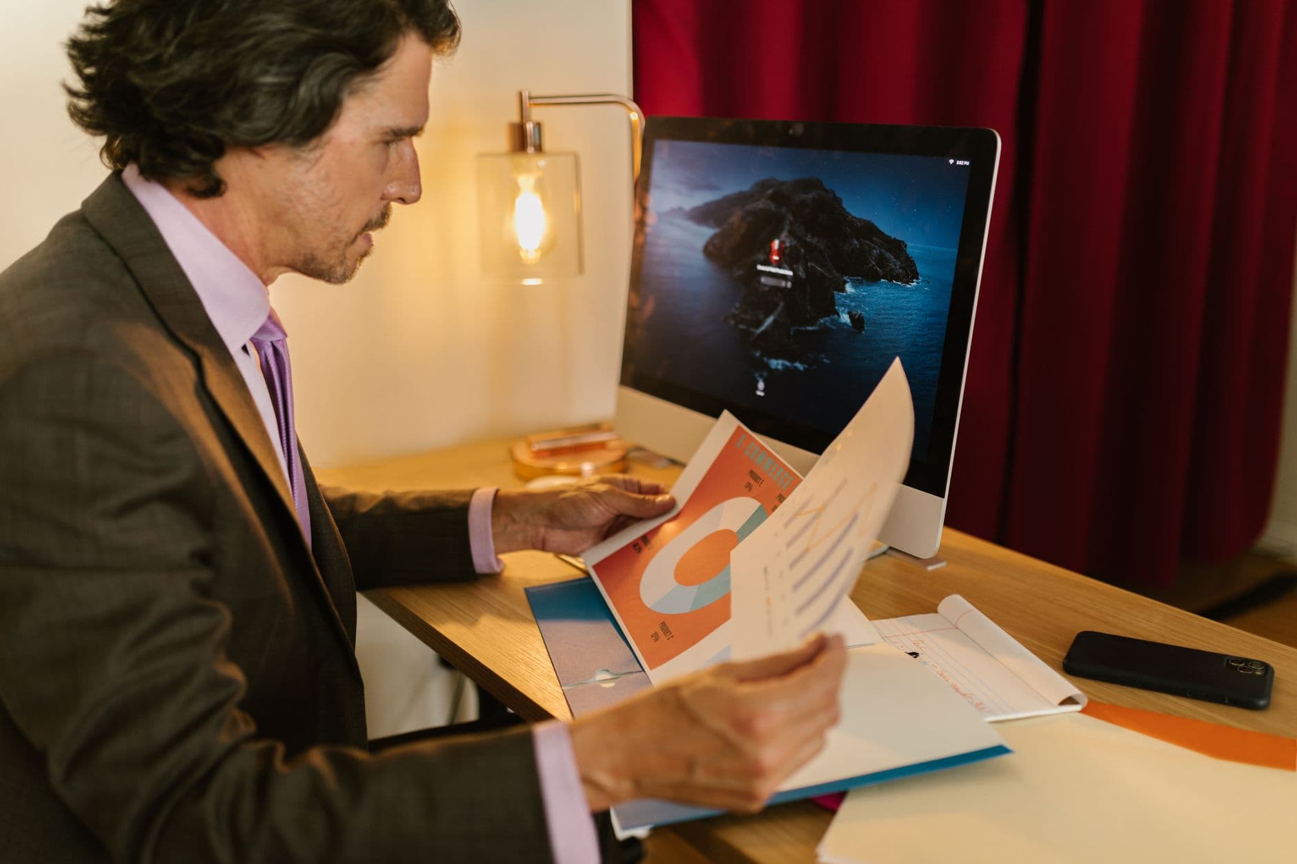 Farmer and accountant reviewing financial documents at a farm office table