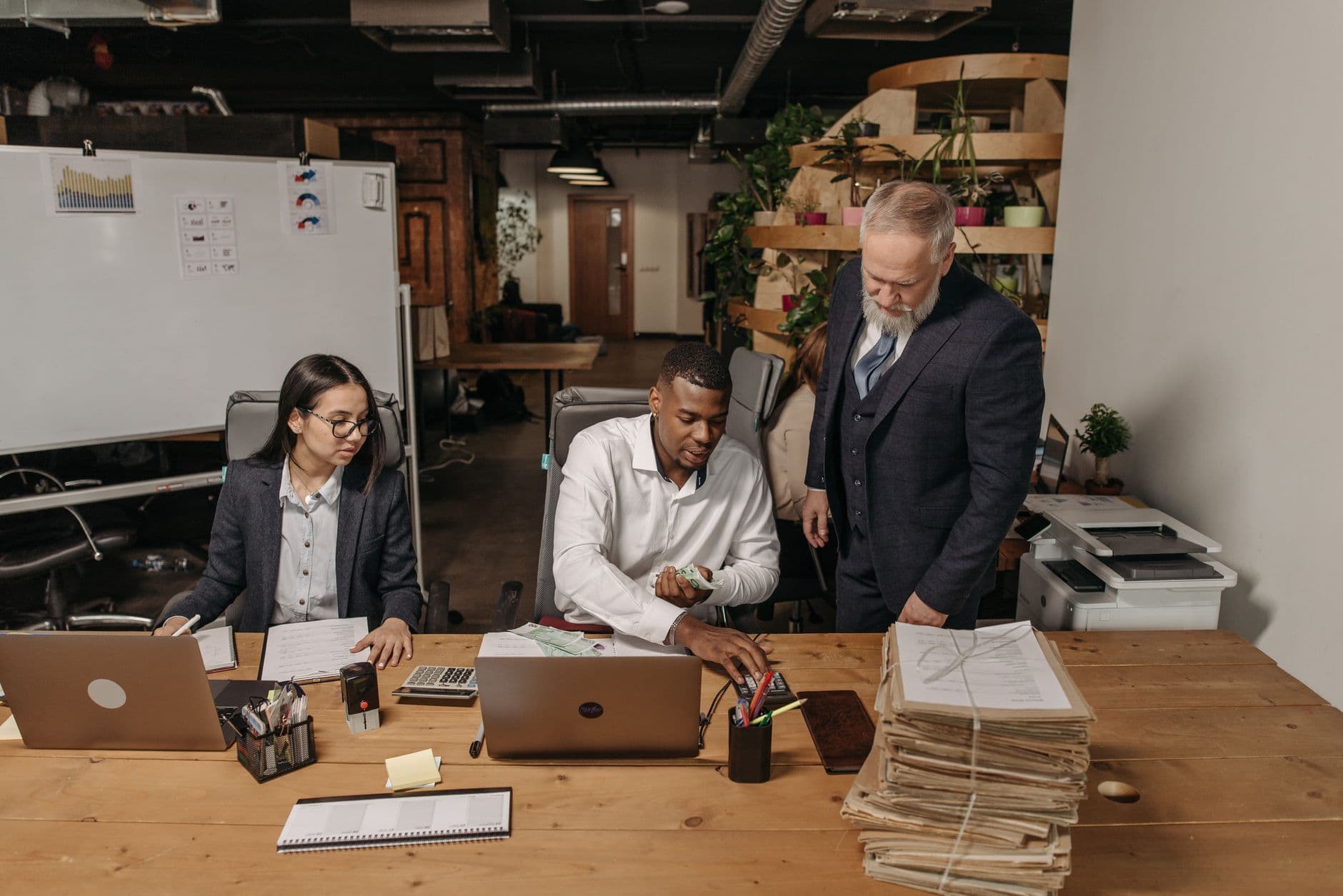 Farm couple reviewing tax paperwork with a CPA in an office