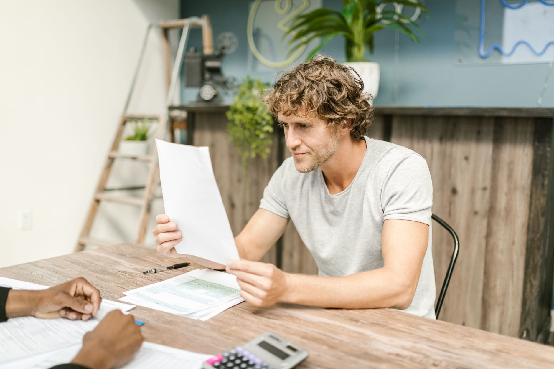 Business owner reviewing bank and credit card statements to spot recurring subscription charges