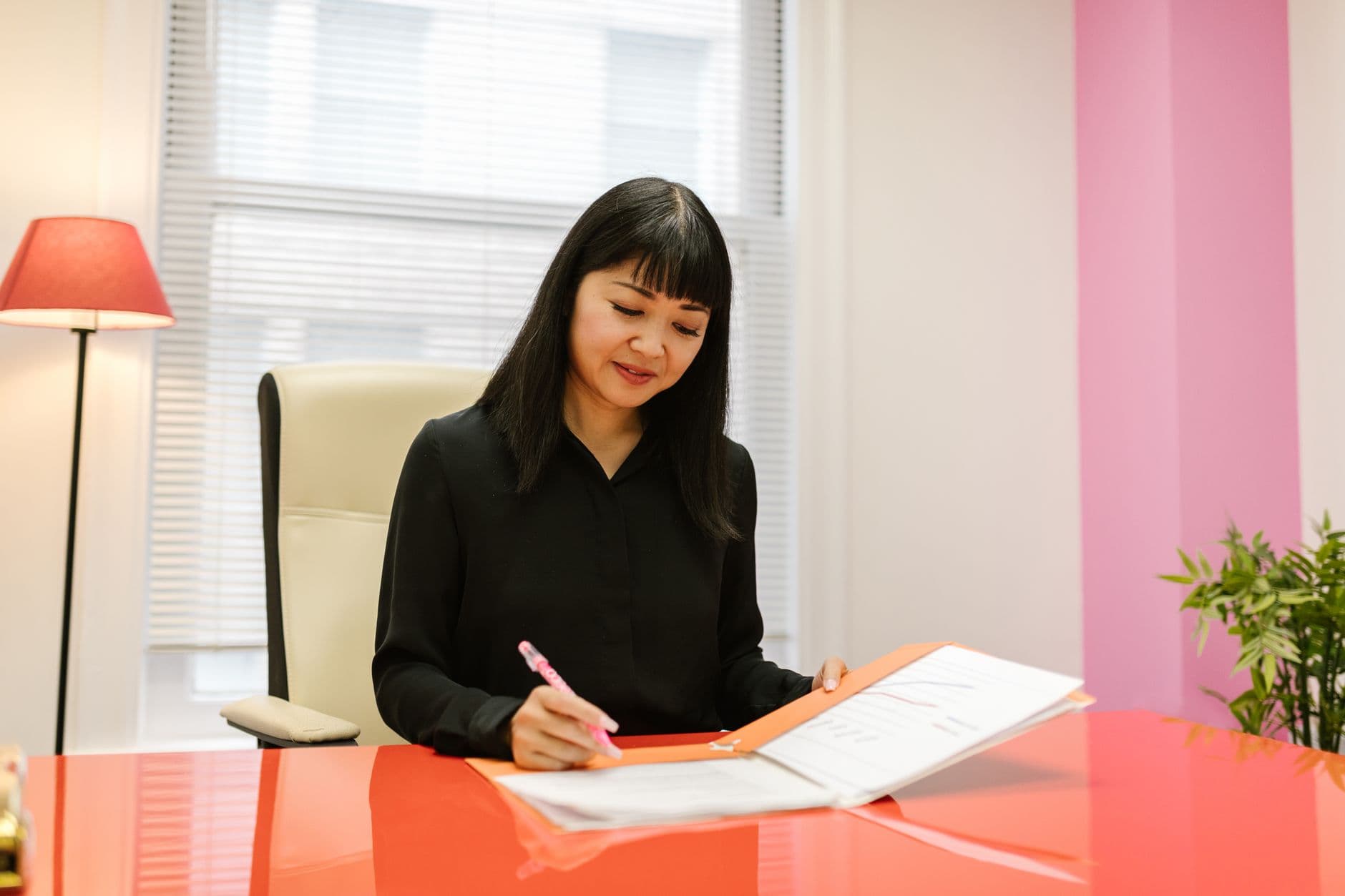 Small business owner reviewing payroll and budget documents at a desk