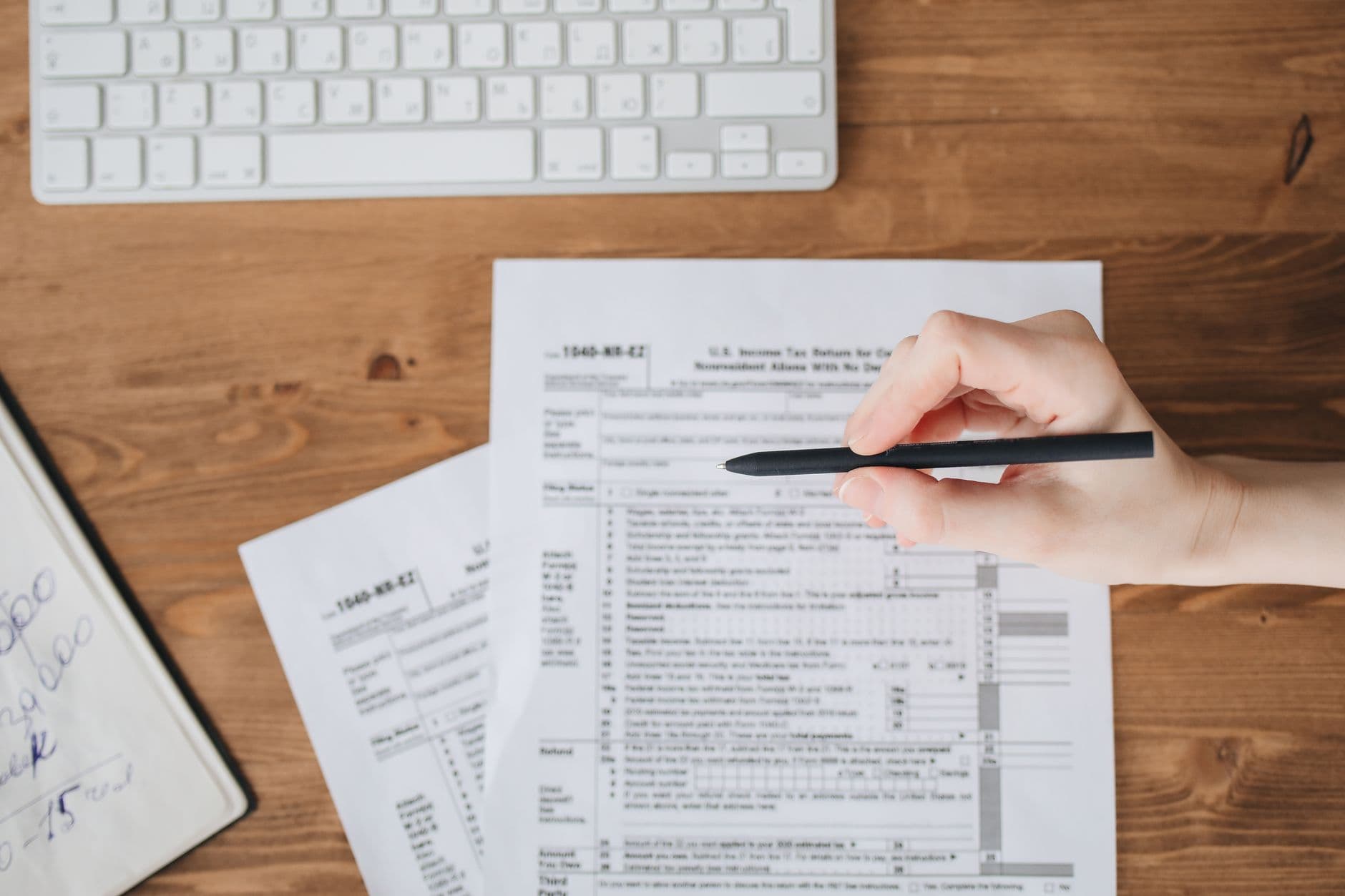 Accountant and farmer reviewing tax documents at a desk