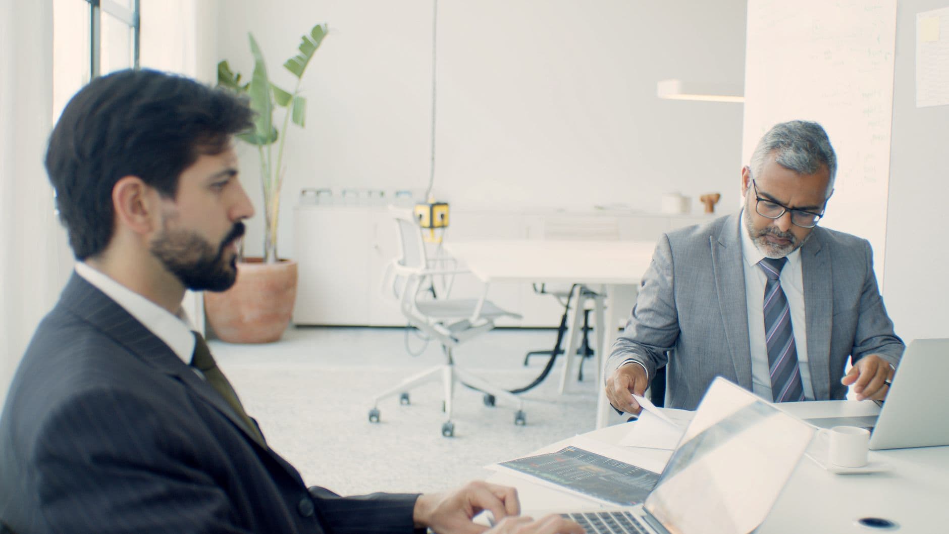 Farmer and accountant discussing tax documents in a farm office