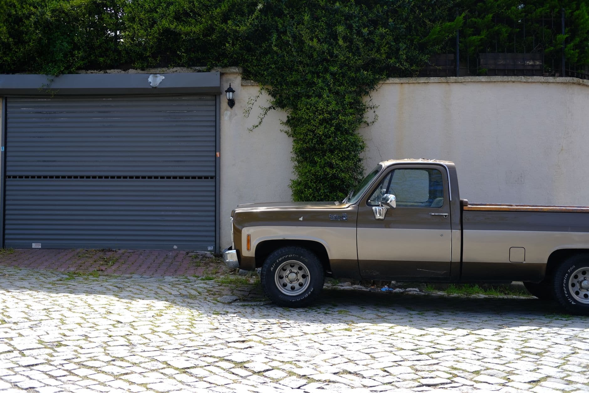 Pickup truck parked in a farm driveway, representing the choice between leasing and buying a business vehicle