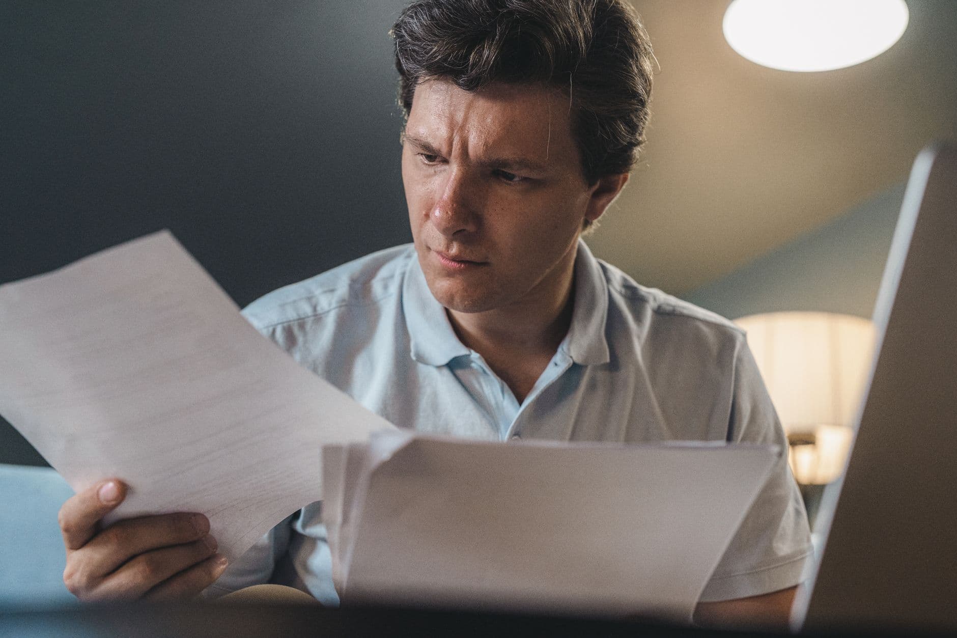 Farmer reviewing retirement account paperwork at kitchen table