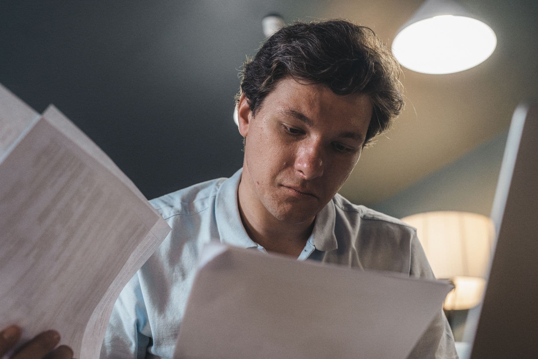 Farm business owner reviewing insurance and financial documents at a desk
