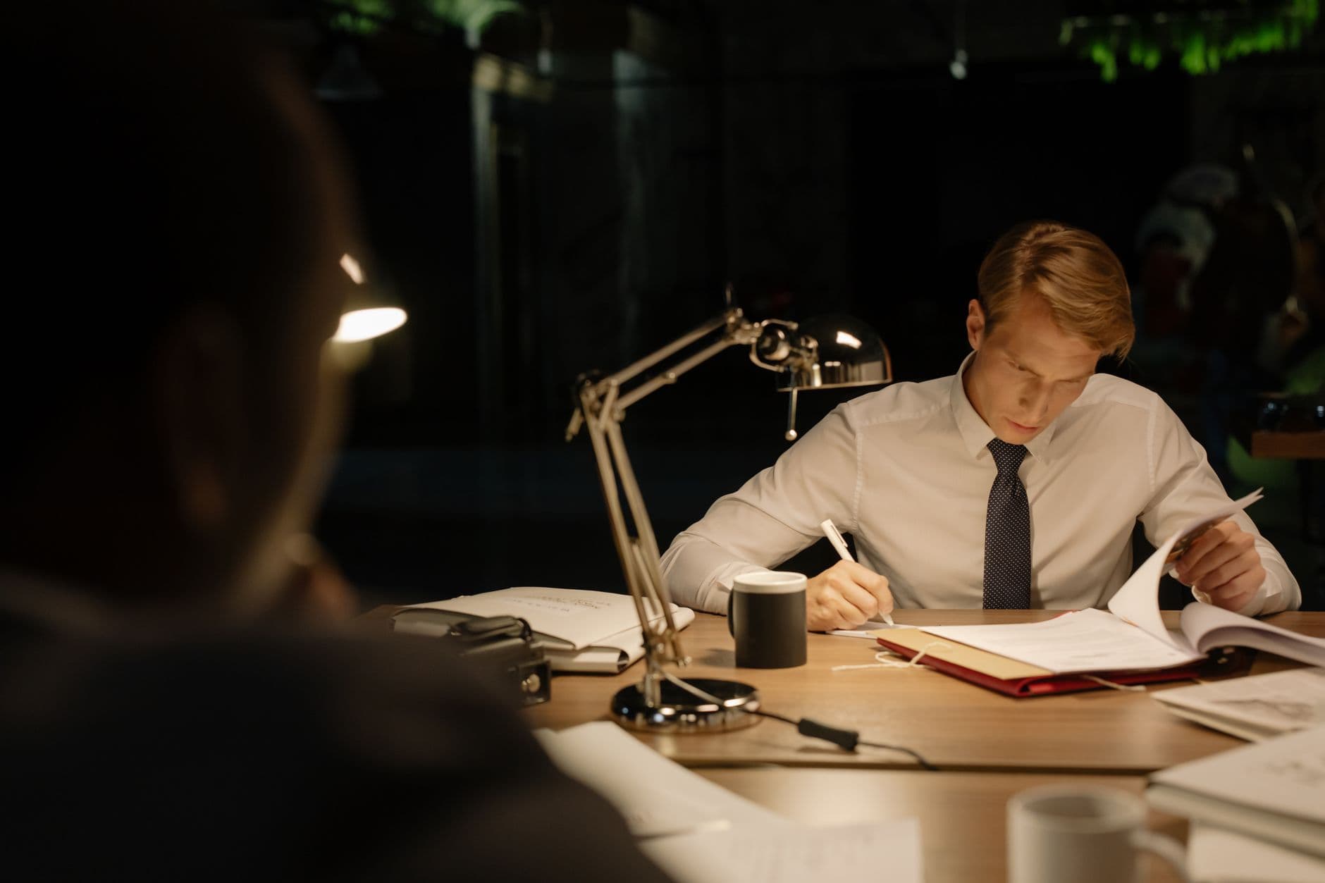 Business owner reviewing financial documents at a desk with a laptop, planning tax strategy ahead of year end