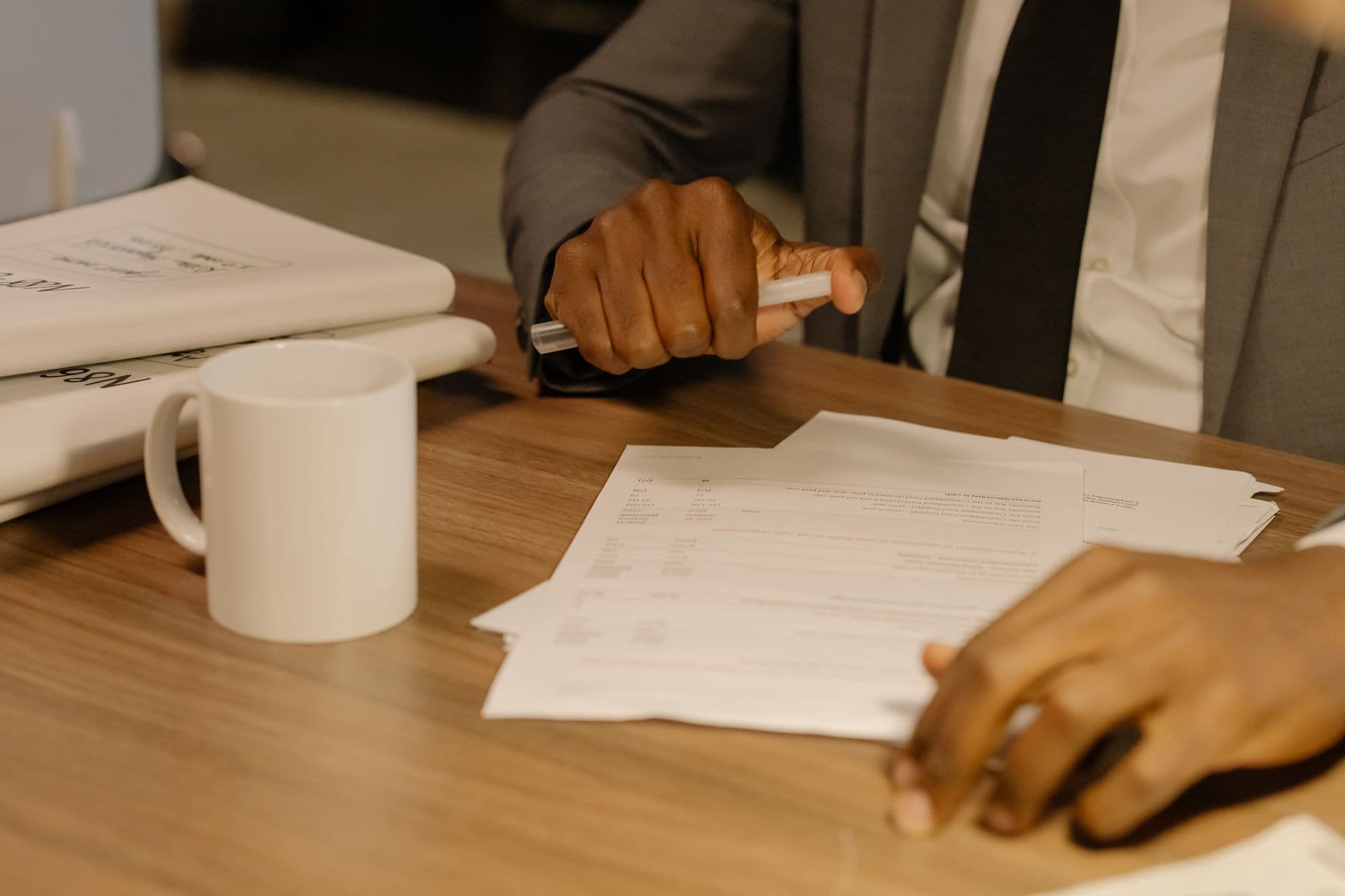 Investor reviewing K-1 tax documents and portfolio statements at a desk