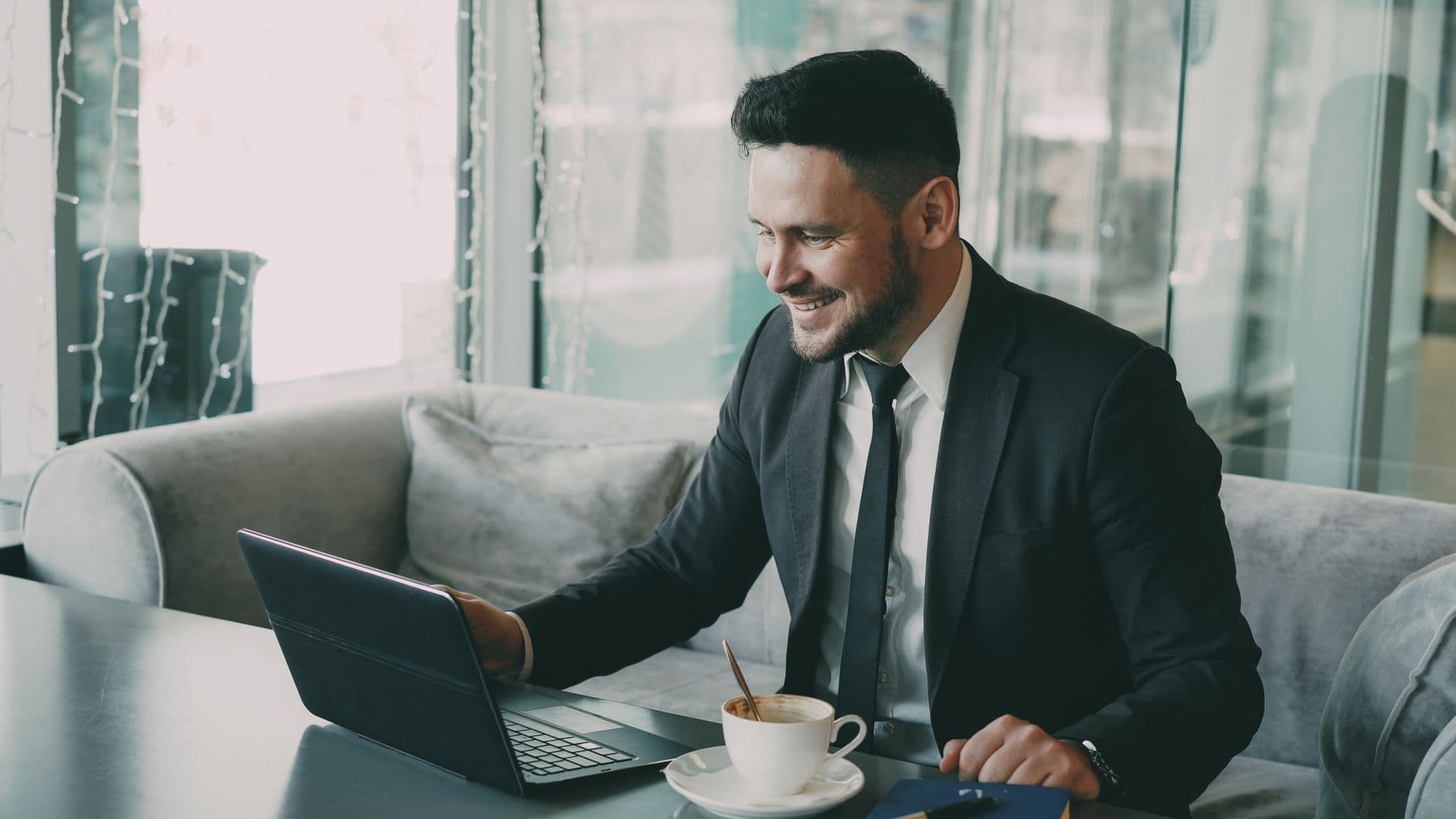 Business owner viewing financial dashboard on a laptop from a workshop