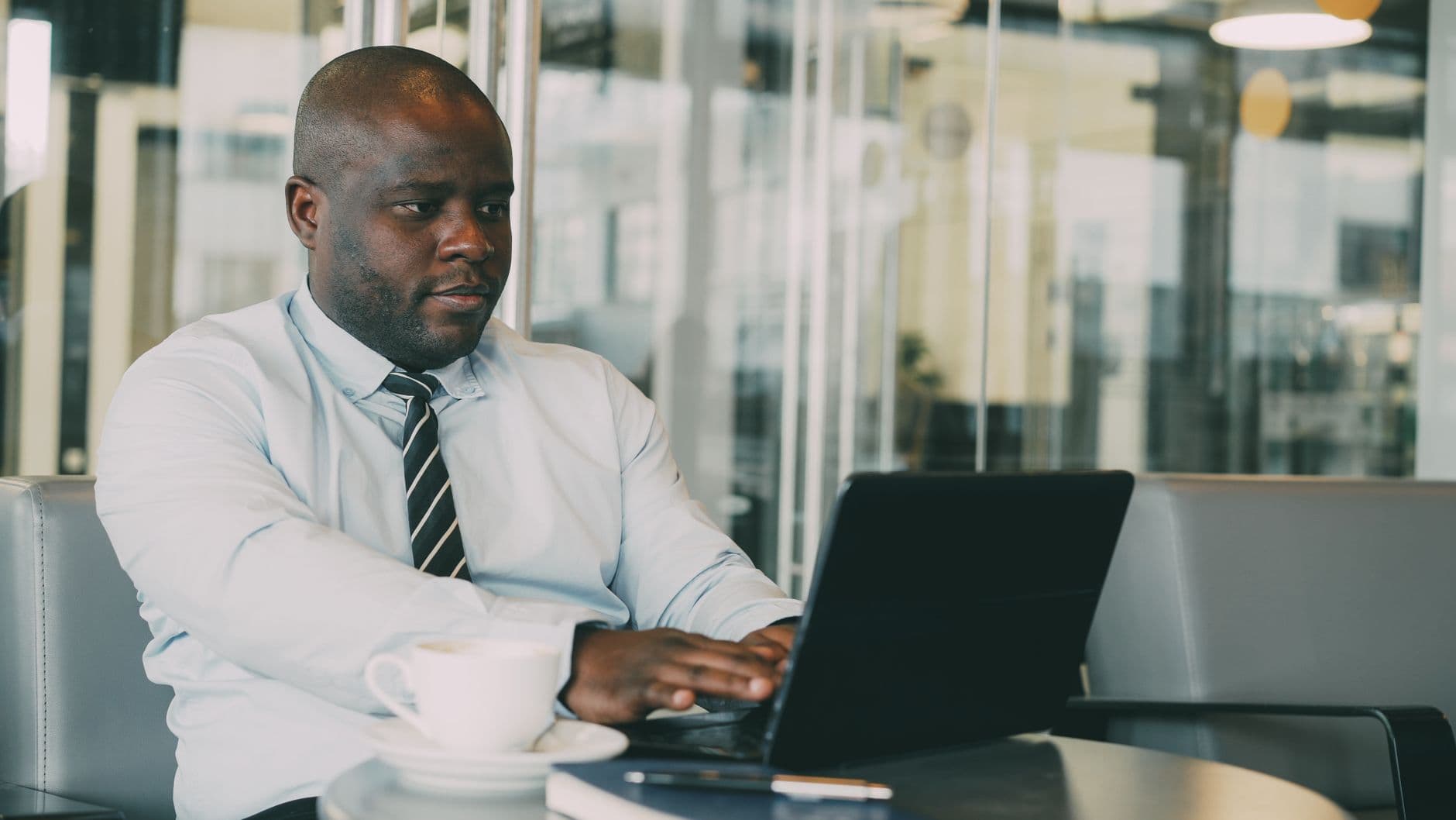 Accountant and business owner reviewing financial reports on a laptop