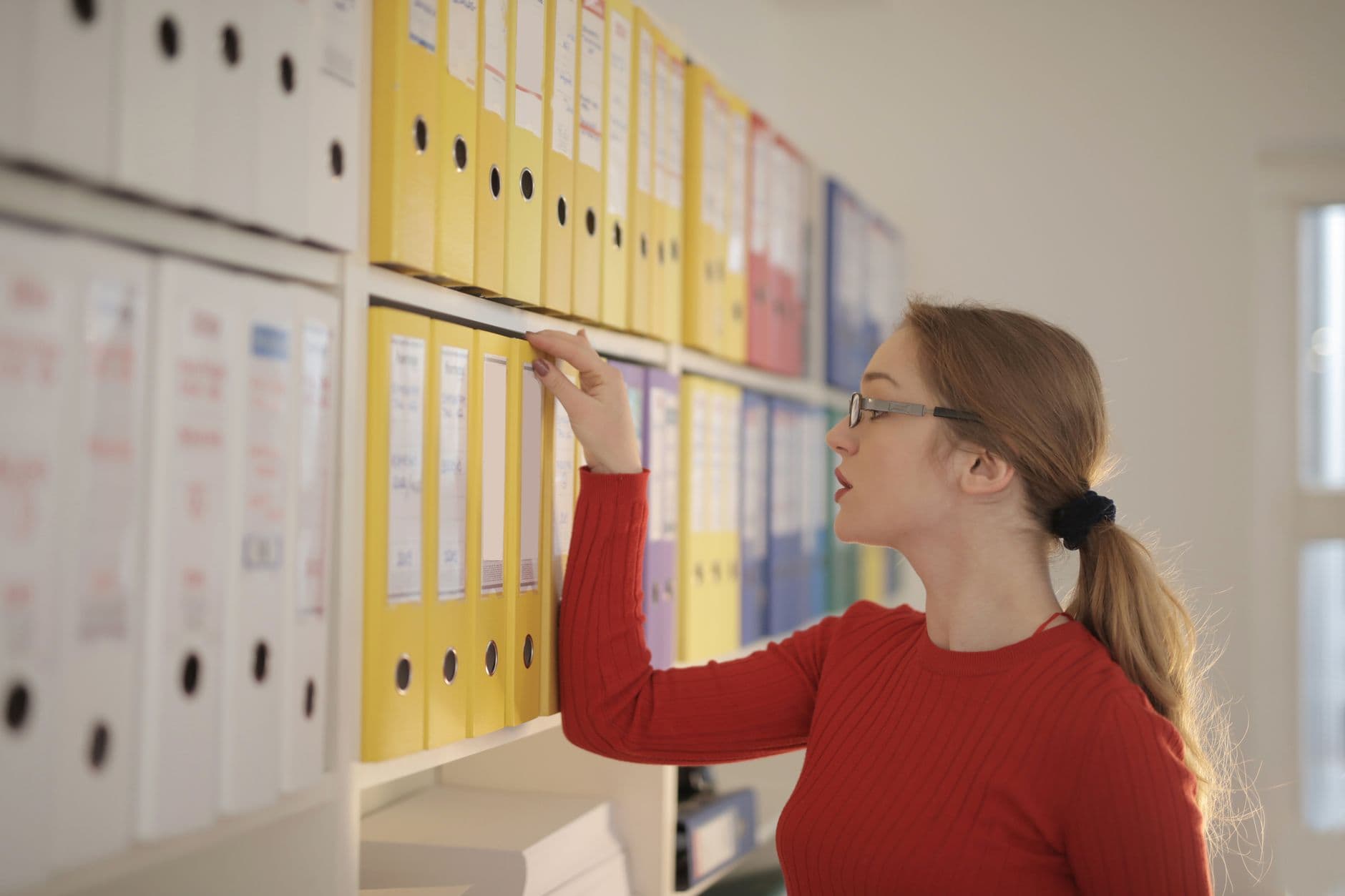 Bookkeeper organizing payroll forms and W-4 documents