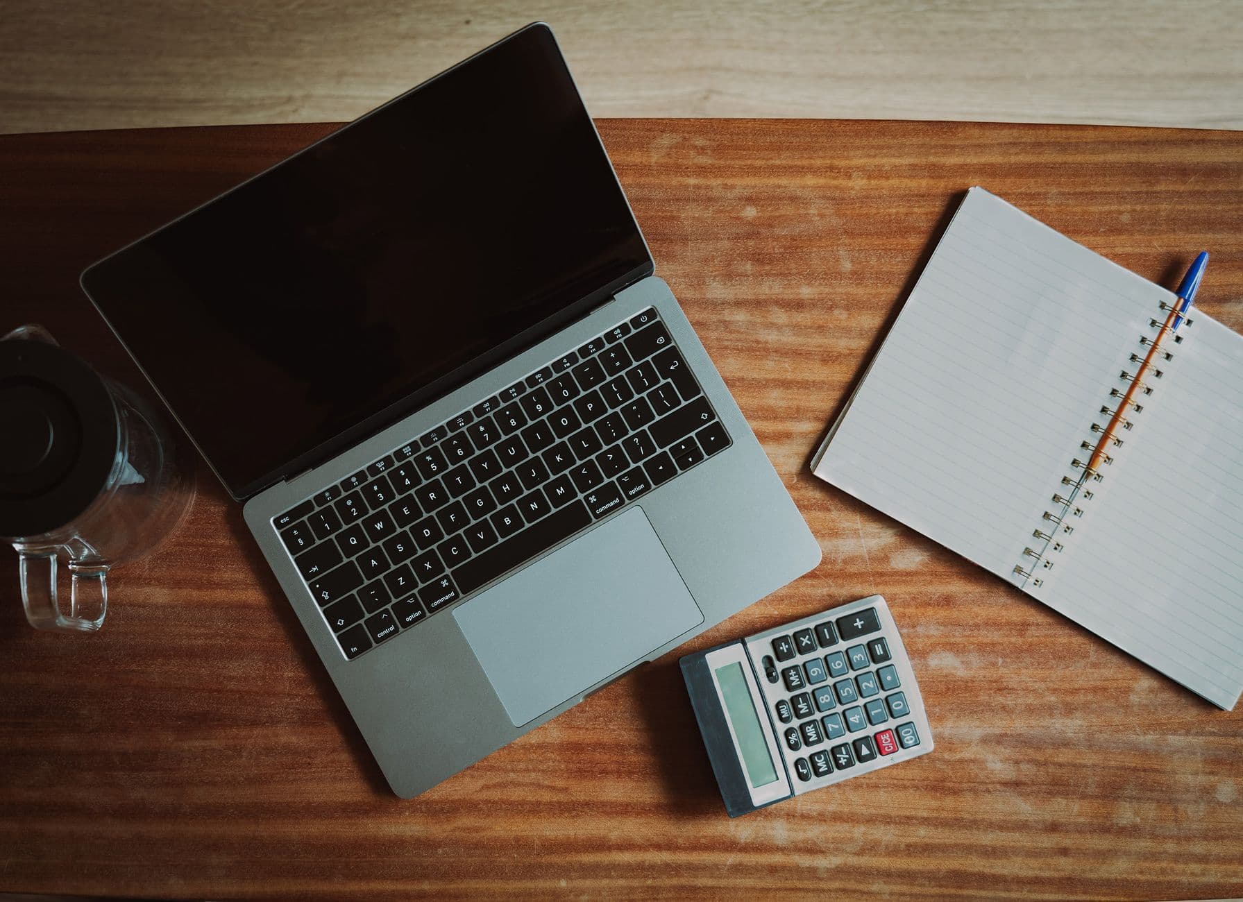 Accountant processing payroll records on a laptop in an office