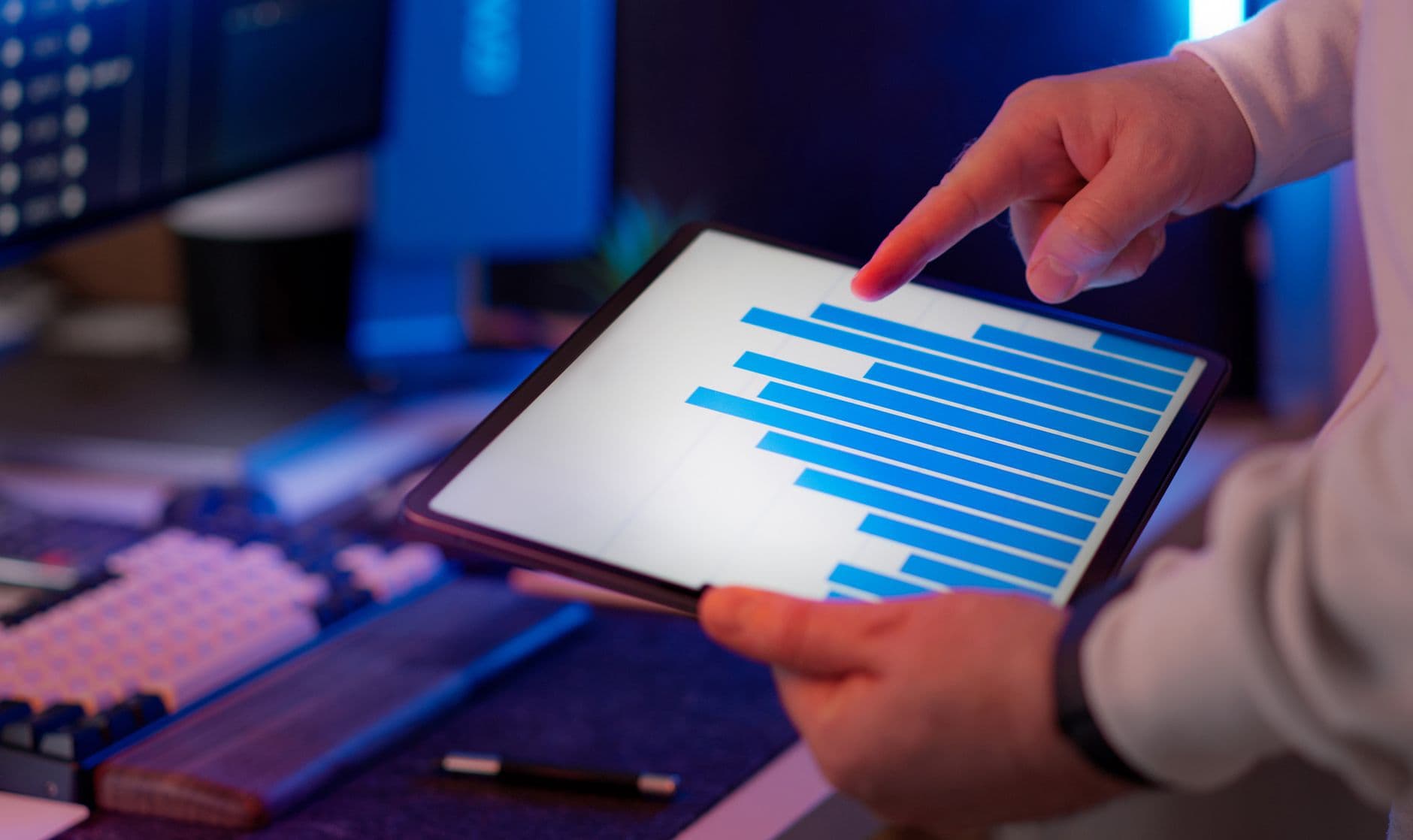 Business owner accessing financial dashboard on a tablet at a desk