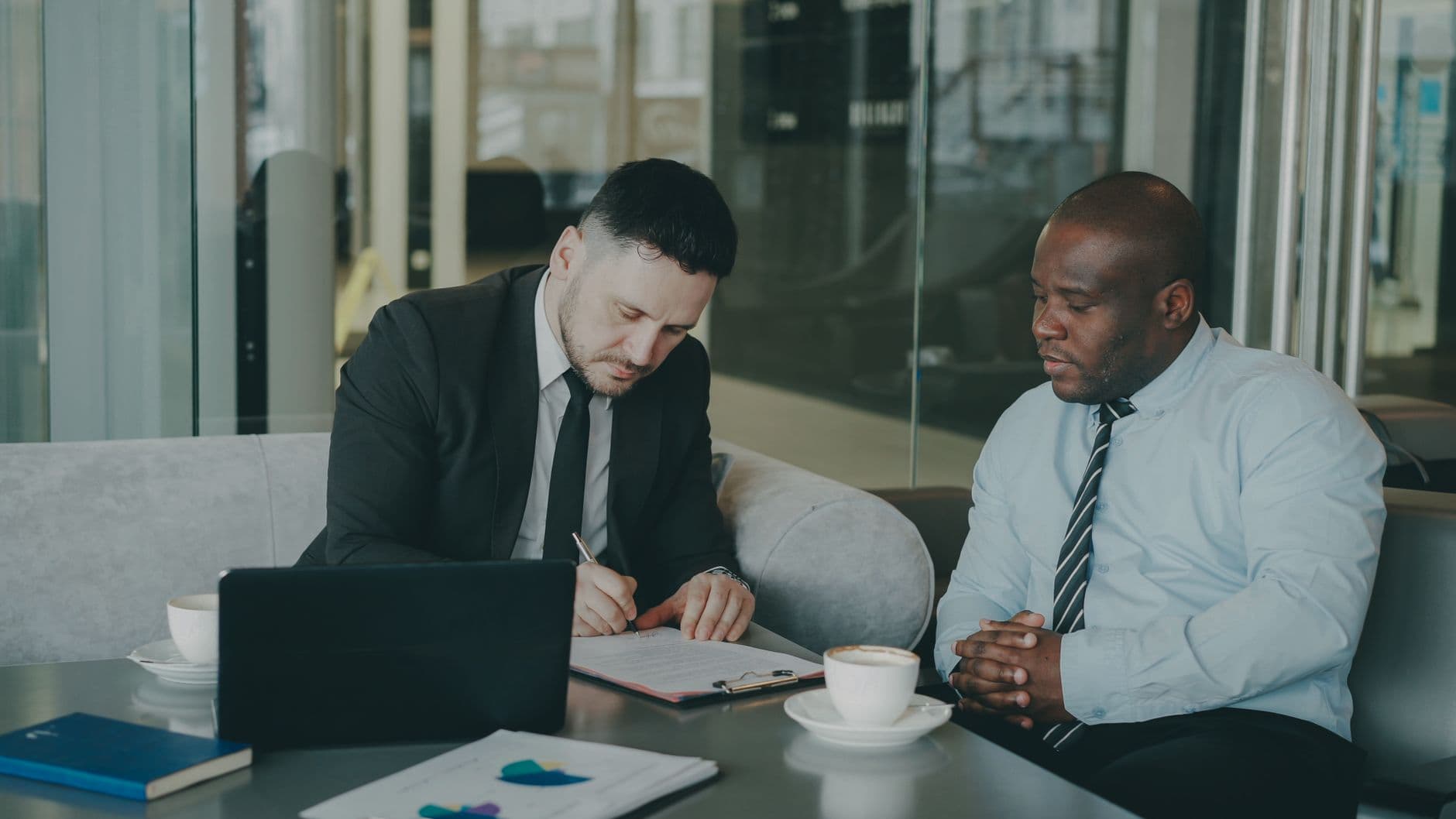 Consultant reviewing financial dashboard on a laptop in a modern office